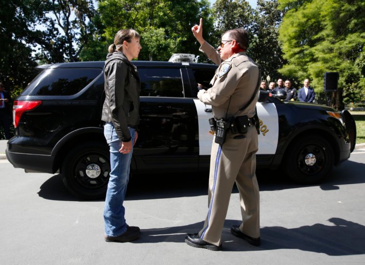 California Highway Patrol Officer Gary Martens, right, has CHP Sgt. Jaimi Kenyon, follow his finger during a demonstration of how drivers, suspected of impaired driving, are currently tested, Wednesday, May 10, 2017, in Sacramento, Calif. Three of California's largest counties are testing a device that can detect the presence of drugs in saliva within five minutes. Some officers and lawmakers want the devices used statewide after voters passed Proposition 64 in November, legalizing the recreational use of marijuana. 