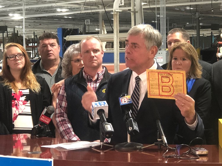 Republican candidate for governor Shawn Moody holds up the first building permit he ever obtained, during a news conference on Moody’s economic development plan in Auburn on Thursday. Moody was just 17 when started his first business, which he grew into a chain of 11 auto body repair shops. 