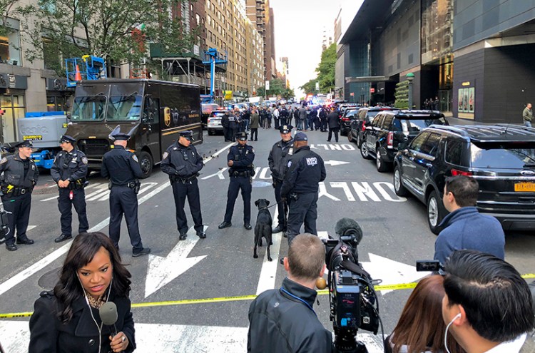 New York Police stand outside the Time Warner Center at Columbus Circle on Wednesday in New York City. A police bomb squad was sent to CNN's offices at the center, and the newsroom was evacuated because of a suspicious package. 