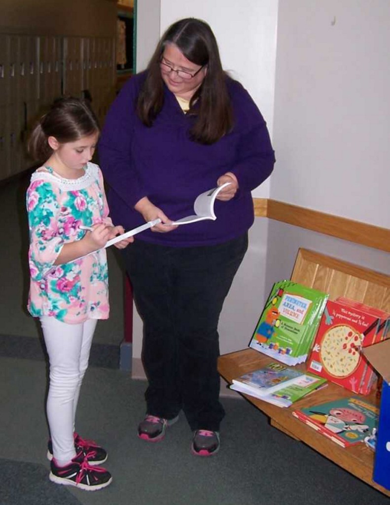 Fourth grader Skylar Thurlow, left, with Title I/Reading Recovery teacher Robin Chase.