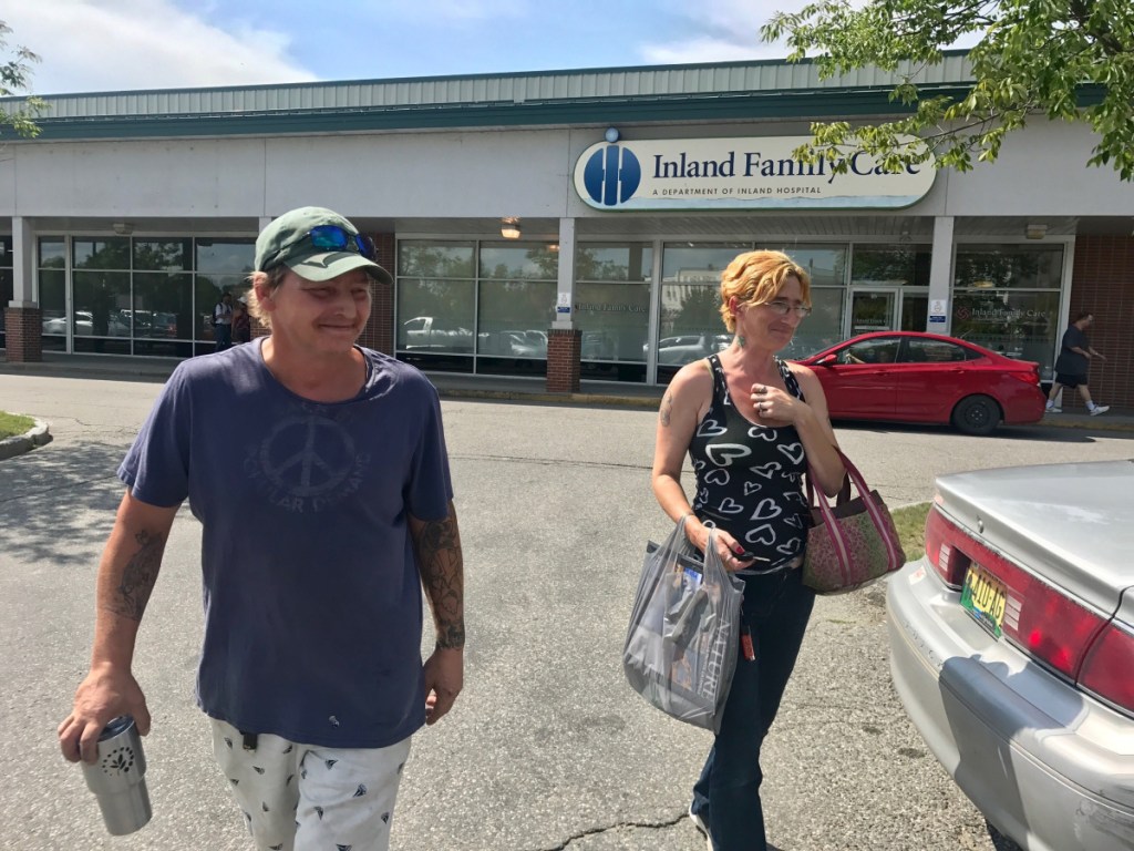 Melvin Hubbard, left, and Bobbie-Sue Glidden, right, leave Dollar Tree in Waterville on Aug. 15, carrying a plastic shopping bag. The pair said they would be against a proposed ordinance to ban plastic shopping bags at retailers over 10,000 square feet.