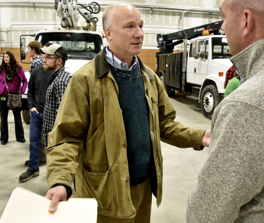 Derek Langhauser, left, president of the Maine Community College System, speaks with Dwight Littlefield during an open house Wednesday in the expanded electrical lineworkers technology program at Kennebec Valley Community College in Fairfield.