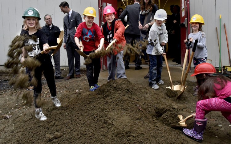 From left, Lilly Howe, Angus Johnson, Nikolai Fay, Silver Picard, Juliet Boivin and Isabella Veilleux take an active part in the groundbreaking ceremony for the Alfond Youth Center Wellness project, scooping up dirt and flinging it toward the photographer after speeches by contributors to the $6.12 million project on Thursday.