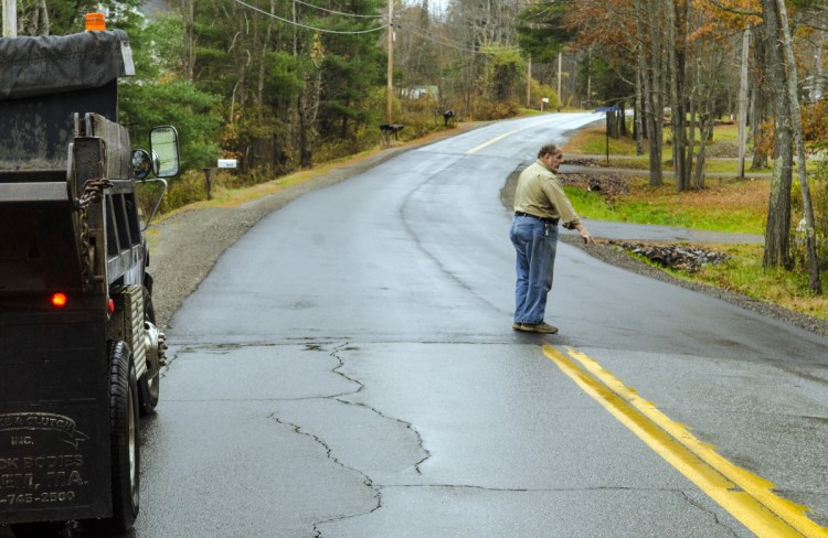 Farmingdale Road Commissioner Steve Stratton talks on Thursday about the pavement level on a recently repaired section of Northern Avenue in Farmingdale.
