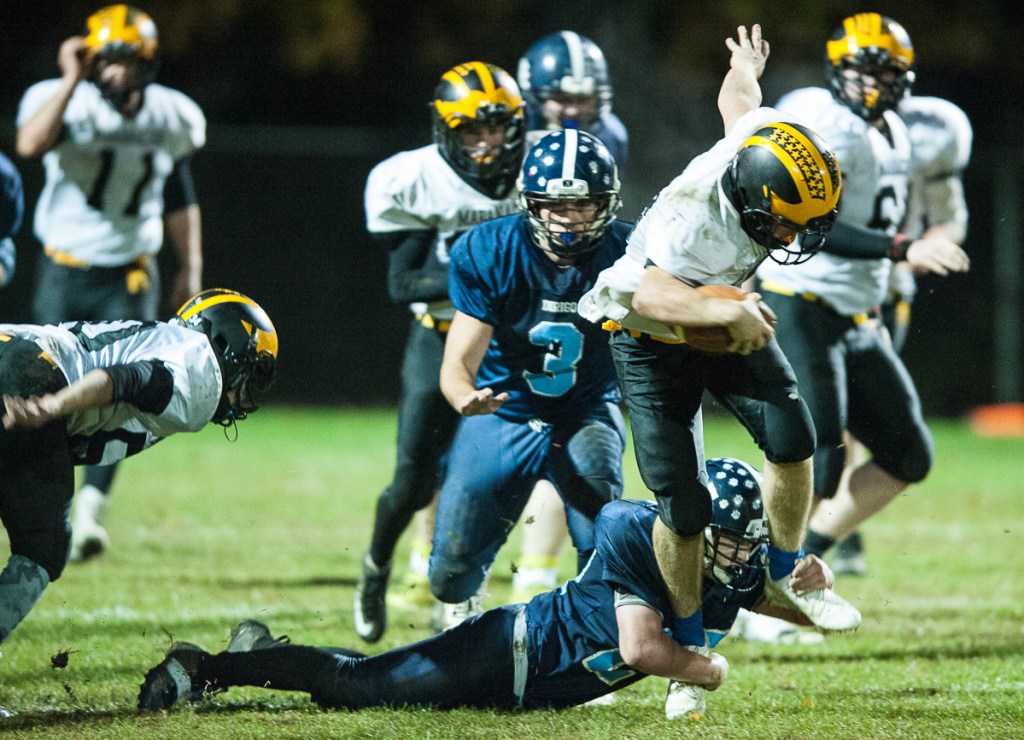 Maranacook quarterback Chris Reid can't escape Dirigo's Dallas Berry as he drags him down before he can get into the secondary during the first half of Friday night's Class E playoff game in Dixfield.