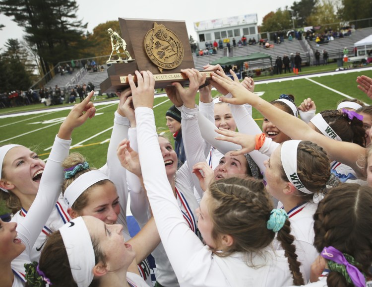 Winthrop celebrates its win over Spruce Mountain in the Class C field hockey state championship Saturday at Deering High School in Portland.