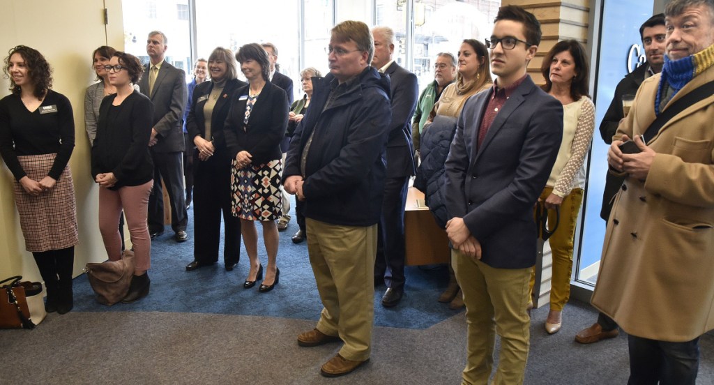 City and bank officials fill the lobby of the new Camden National Bank as speakers participate in a grand opening ceremony Monday in Waterville at the Bill & Joan Alfond Main Street Commons building.