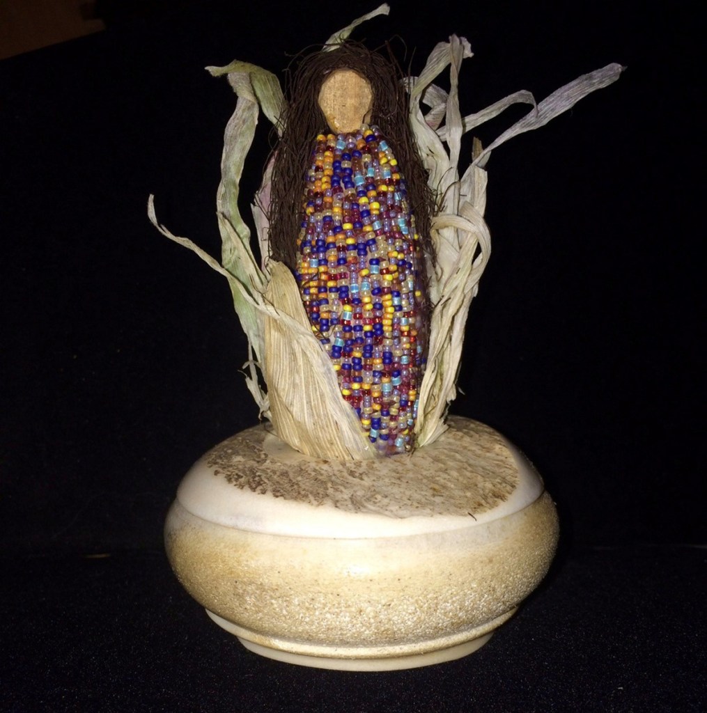 "Corn Mother," by Kathy Pollard, glass beads, corn husks and a moose antler.