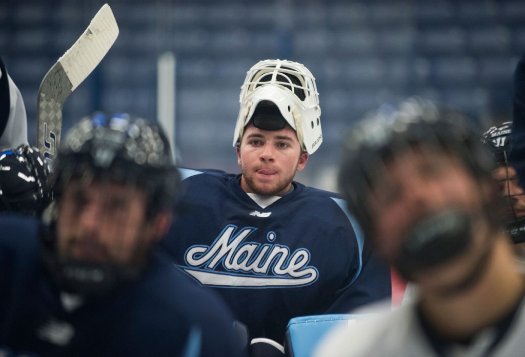 Maine sophomore goalie Jeremy Swayman listens to coaches during a break in practice at Alfond Arena in Orono earlier this season.
