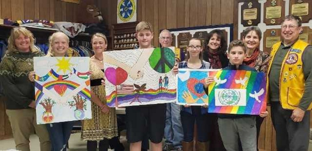 Winners of the Peace Poster Contest with their respective art teachers, from left, were Rachel Richmond and Abby St. Cyr, from Jefferson Village School; Amanda Martin and Lineo Kelley, from Whitefield Elementary; Lion Calvin Prescott; Alyvia Colfer and Sandy Dunn, from Chelsea Elementary; Nathan Hall and Genevieve Keller, from Windsor Elementary; and Lion Barry Tibbetts.