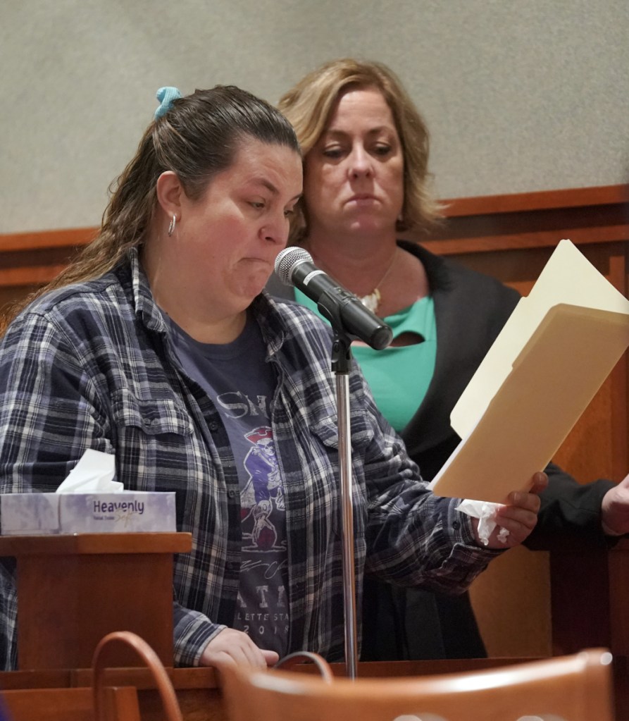 Victoria Beloin, standing with Michelle Cran, a victim-witness advocate, reads a statement Friday during David Marble's sentencing hearing at the Cumberland County Courthouse in Portland. Marble, who was found guilty of murdering Eric Williams and Bonnie Royer, was sentenced to life in prison without the possibility of parole. Beloin is the partner of Royer's father.