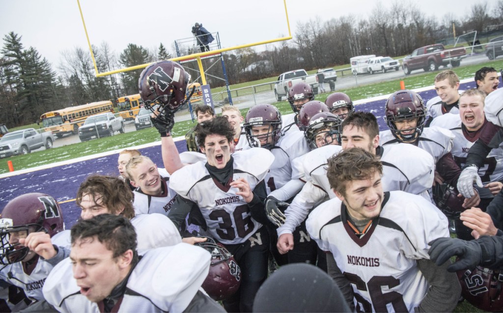 Staff photo by Michael G. Seamans 
 Nokomis celebrates its 13-6 win over Hermon in the Class C championship game Saturday at Hampden Academy.