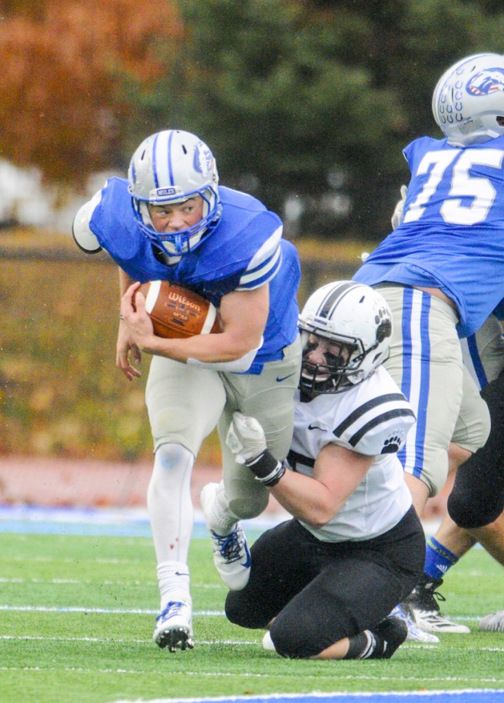 Colby running back Jake Schwern gets tackled by Bowdoin's Liam Dougherty on Saturday in Waterville.