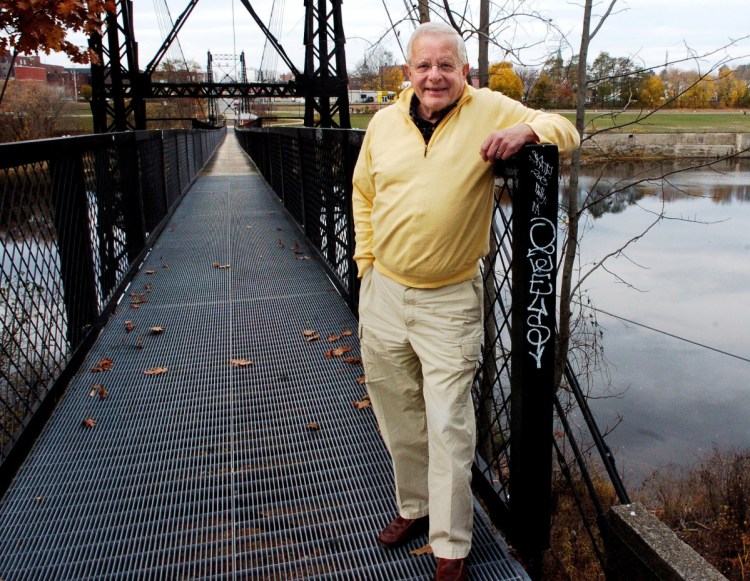 Earl Smith, shown in November 2016 at the Two Cent Bridge at Head of Falls with Waterville in the background, will read from his newest book, "Water Village, The Story of Waterville, Maine," commissioned by Mid-Maine Chamber of Commerce, on Thursday at the Waterville Opera House.