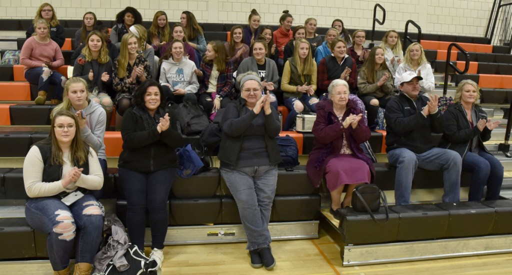 Family and team members of Skowhegan field hockey players Lizzie York and Maliea Kelso applaud after the students signed letters of intent to play for Division I colleges Wednesday in Skowhegan.