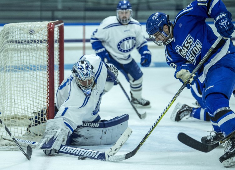 Colby College goalie Andrew Tucci (1) makes a save against UMass Boston's Zach Bross (18) during a game last season at Alfond Rink in Waterville.