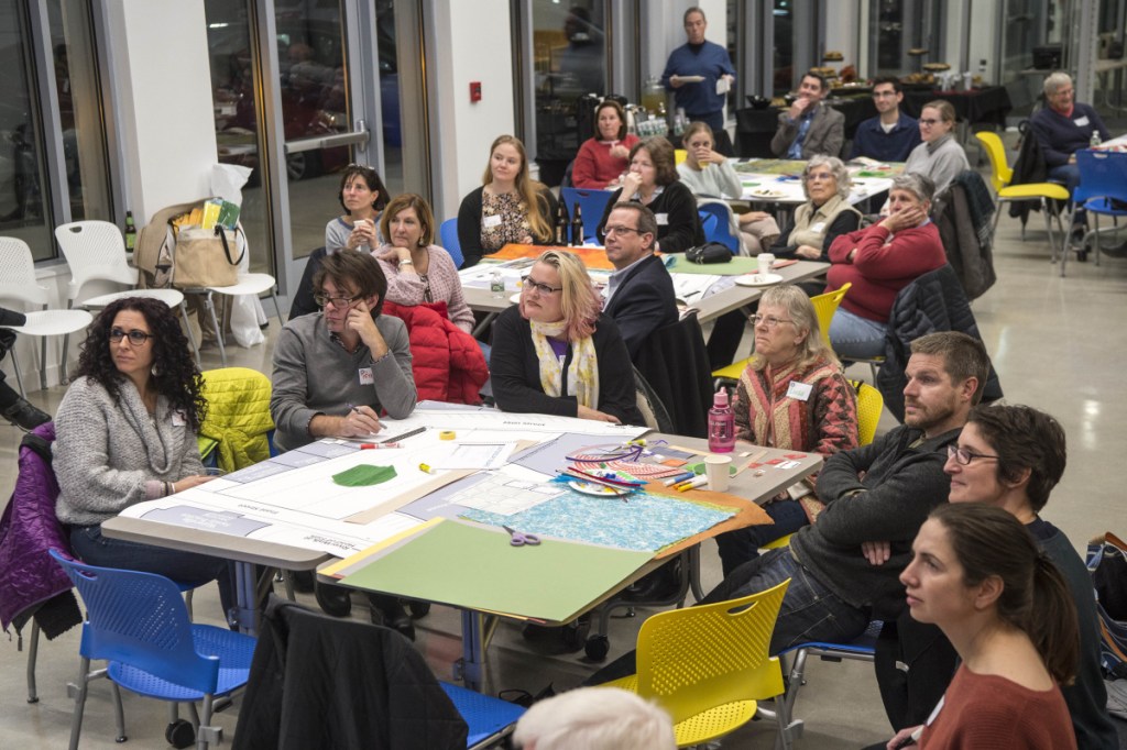 Members of the community gather on Wednesday at the Bill and Joan Alfond Commons as Neil Kittredge, an architect with Beyer, Binder and Belle, discusses design approaches for the new arts center and Castonguay Square during a community workshop.