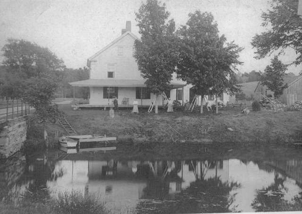 Summer visitors enjoy leisure time at the Meserve House by the Bridge on Davis Stream. The photo is one of 40 photos featured in the 2019 version of the JHS's 2019 calendar.