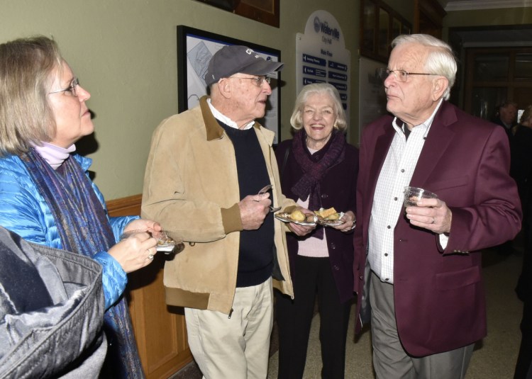 Earl Smith, right, speaks with, from left, Cate Ashton and Karl and Jane Dornish, during a reception for Smith, who gave a presentation on his new book, "Water Village, The Story of Waterville, Maine," on Thursday at the Opera House.