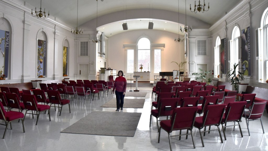 April Cummings, co-owner of Half Pints Day Care located within the First Congregational Church building in Waterville, walks through the church nave on Monday. The Children's Discovery Museum is hoping to lease the church with the intention of purchasing it for the museum.