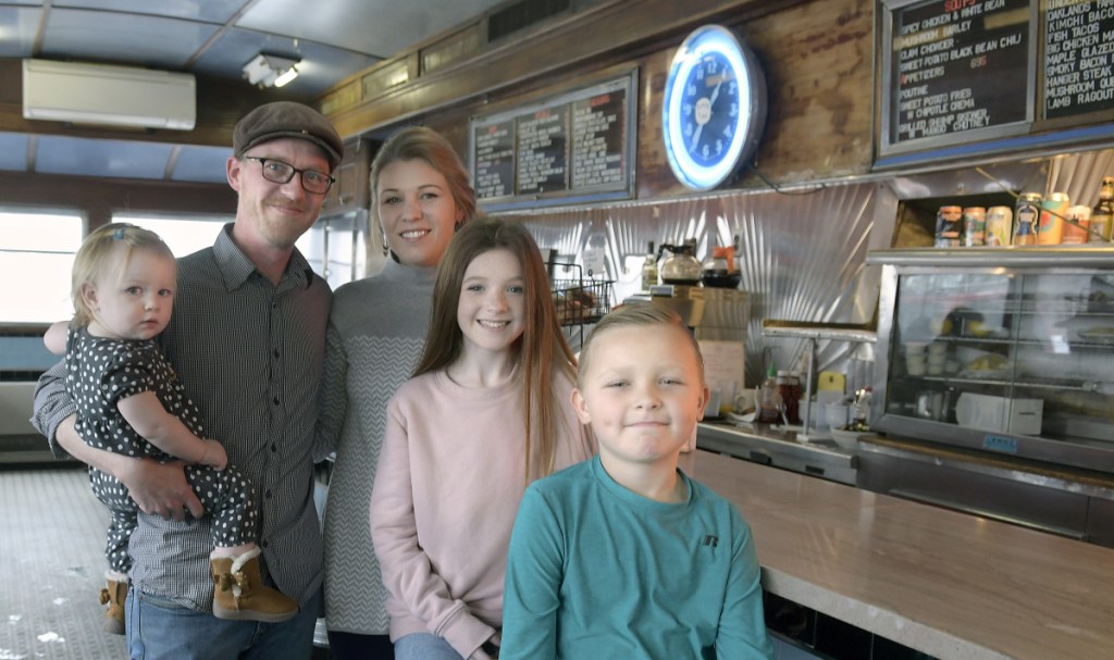 Aaron Harris with his wife, Sarah, and children Eleanor, 1, left, Spencer, 8, and Olivia, 11, at the A1 Diner in Gardiner. After three decades, Michael Giberson and Neil Andersen are handing the reins of the institution over to Aaron Harris. The family gathered on Monday at the Diner.