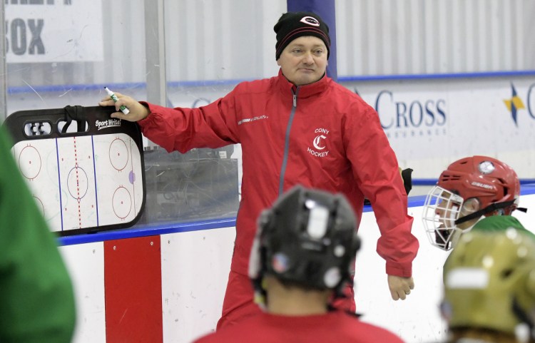 New Cony hockey coach Shawn Johnson goes over a drill during the first day of pracrice Monday in Hallowell.