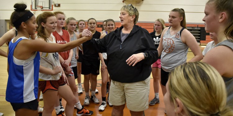 Maine Basketball Hall of Fame member and Winslow girls head basketball coach Brenda Beckwith gathers the team during practice Monday in Winslow.