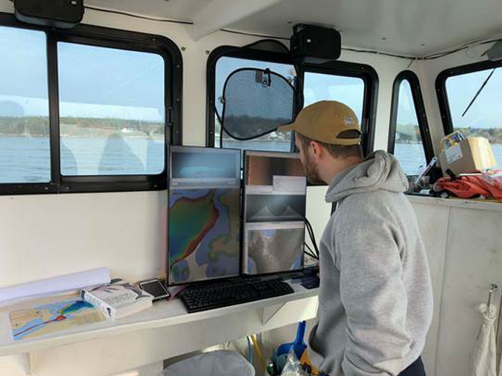 Ben Kraun monitors data from the multibeam echosounder system this year while out on the Amy Gale searching for the wreck of the Angel Gabriel in Bristol.
