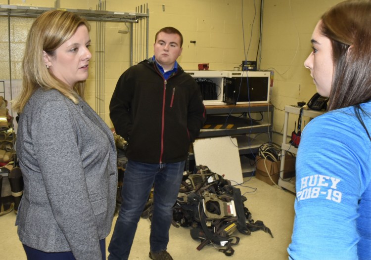 Beth Carlton, left, student services coordinator at Mid-Maine Technical Center in Waterville, on Nov. 15, speaks with students Bryce Scott and Michaela Huey about the "Say Something" app for cellphones. Students will be offered the app to be used to notify officials if they hear or read inappropriate threats or comments.