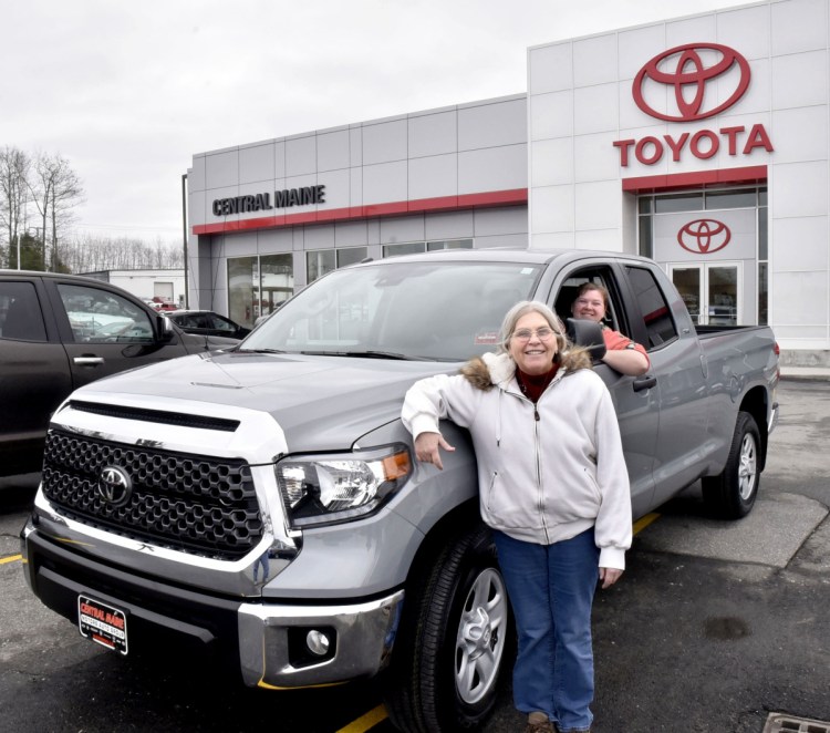 Sue Quimby, left, of Palmyra, stands on Thursday beside her new Toyota Tundra pickup truck at Central Maine Auto Group Toyota dealership in Waterville. Quimby won the truck in the national Bassmaster Toyota Ultimate Tundra Giveaway contest. Her daughter Alice Humphrey is behind the wheel.