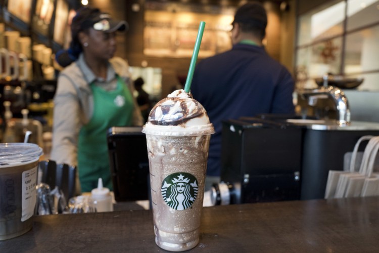 In this June 20 file photo, a Venti Mocha Frappuccino is displayed at a Starbucks. Starbucks served up its holiday cup designs Thursday.