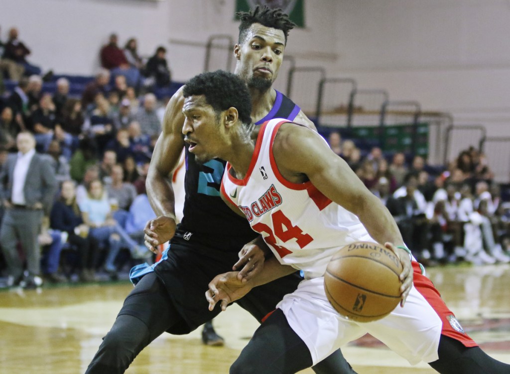 PORTLAND, ME - NOVEMBER 26: Maine Red Claws #24 Andrew White drives around Greensboro #25 Charles Cooke in third quarter action vs. Greensboro Swarm at the Portland Expo.  (Staff photo by Jill Brady/Staff Photographer)