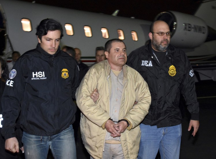 Authorities escort Joaquin "El Chapo" Guzman from a plane in January 2017 at Long Island MacArthur Airport in Ronkonkoma, N.Y., after he was extradited from Mexico. His drug conspiracy trial begins Monday in New York City.