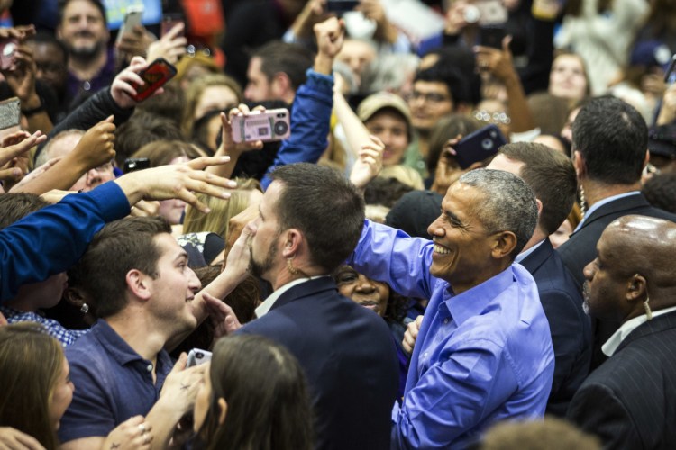 Former President Obama greets people at a rally for Illinois Democrats on Sunday in Chicago.