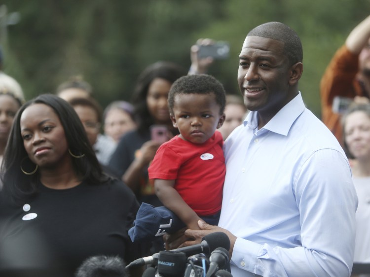 Florida Democratic candidate for governor, Mayor Andrew Gillum, takes questions from the press accompanied by his wife, R. Jai Gillum, and children after casting their ballots at the Good Shepherd Catholic Church Precinct in Tallahassee, Florida, on Tuesday.