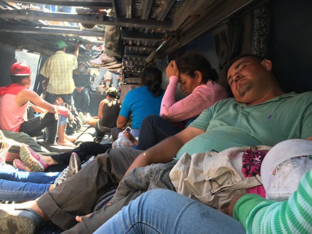 Wilmer, 38, of Guatemala, passes out from exhaustion Monday on the lower deck of a truck ferrying migrants from the city of Cordoba, Mexico, to Puebla, Mexico, part of a parade of people heading toward the United States.