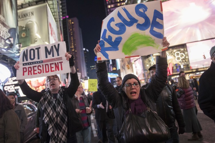 Protesters march through Times Square in New York on Thursday night in a demonstration in support of special counsel Robert Mueller. The protest drew several hundred people calling for the protection of Mueller's investigation into potential coordination between Russia and President Trump's 2016 campaign.