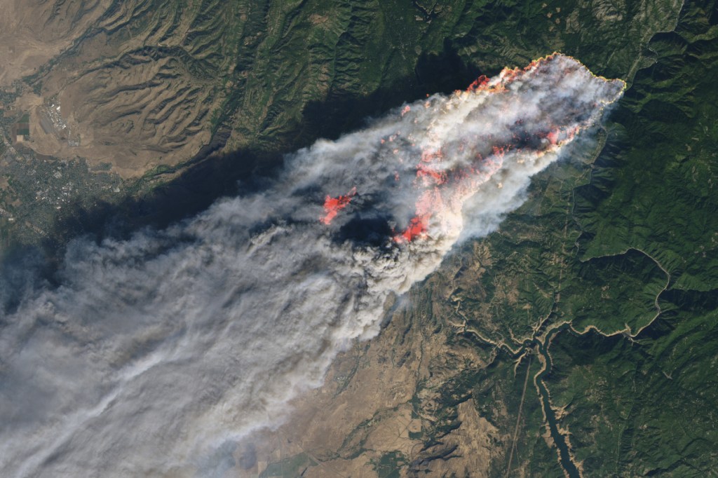 This enhanced satellite image provided by NASA's Earth Observatory, shows a wildfire in Paradise, Calif., on Thursday, Nov. 8, 2018. The fire incinerated most of a town of about 30,000 people with flames that moved so fast there was nothing firefighters could do, authorities said Friday, Nov. 9, 2018. Flames in the image were enhanced with infrared data. (NASA via AP)