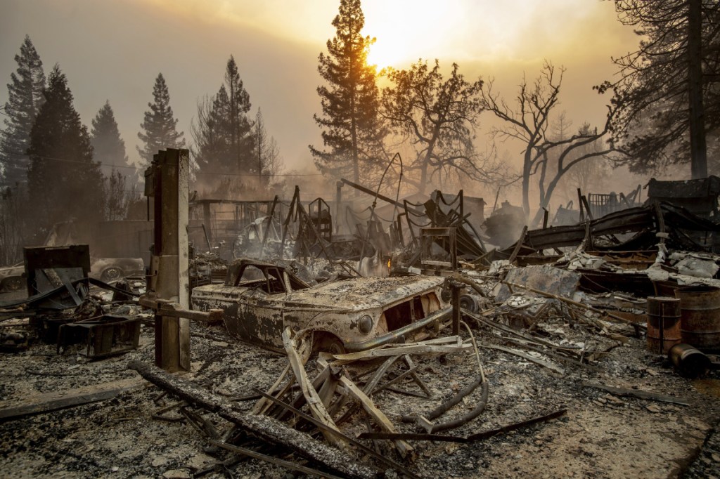 A vintage car rests among debris as a wildfire ravages Paradise, Calif., a town of about 30,000. Several of those killed were found inside burned-out cars. Drivers fleeing Paradise could feel the heat from the blaze as they waited in traffic.