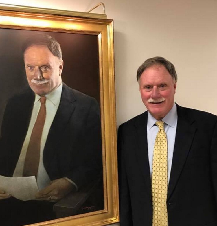 Peter Chalke stands next to his portrait in the Peter E. Chalke Wing of Central Maine Healthcare during the wing's Dec. 5, 2015, dedication.