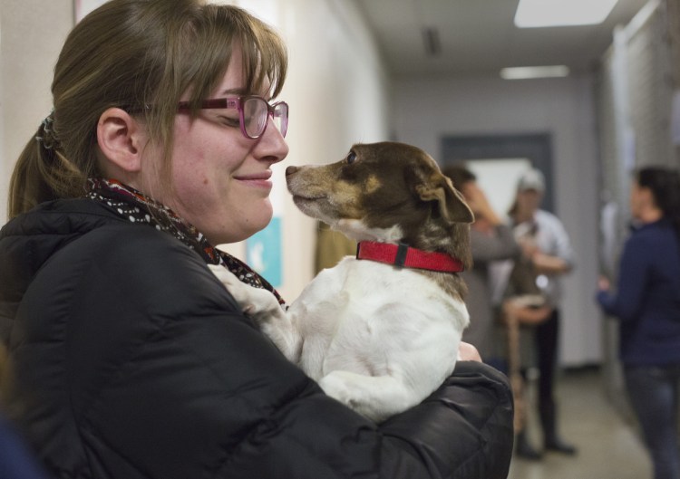 Betsy Caron of Portland holds Pocahontas, the seized dog she adopted Saturday at Midcoast Humane Society.