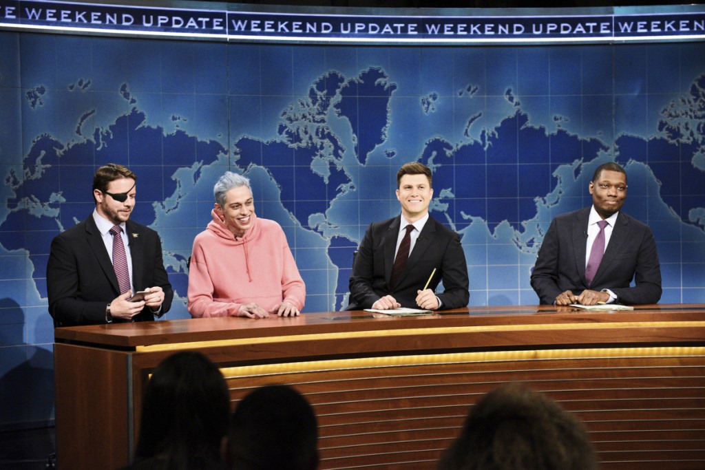 Lt. Cmdr. Dan Crenshaw, from left, Pete Davidson, Colin Jost, and Michael Che appear during Saturday Night Live's "Weekend Update" in New York. 