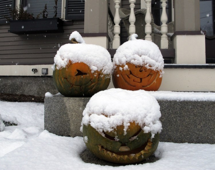 Jack-o'-lanterns are covered in snow Tuesday on the front stoop of a house in Montpelier, Vt. Maine's highest accumulation of 7 inches was in Sangerville, about 45 miles northwest of Bangor.