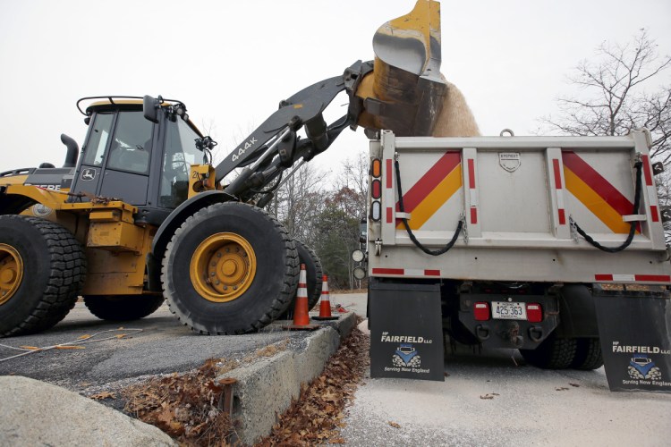 Adam Enman, a mechanic for the Cape Elizabeth Public Works Department, uses a bucket loader to dump road salt into the last of the town's fleet of trucks Thursday in preparation for a winter storm. "We load up three trucks and hope we don't use any of them," Enman joked.