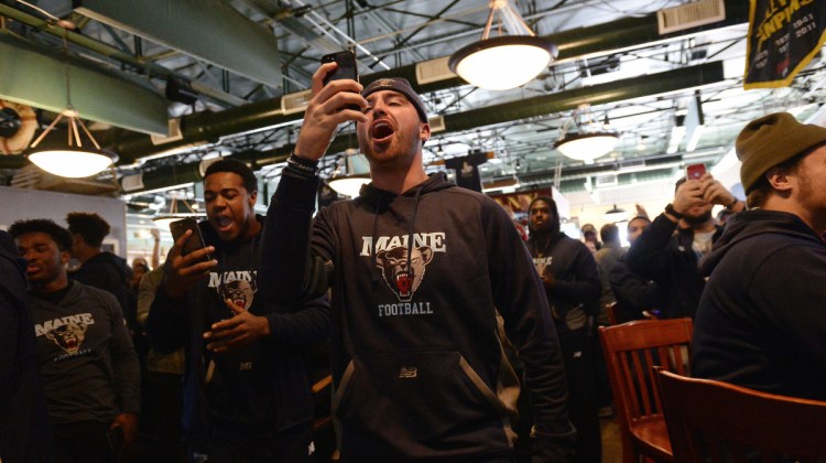 Drew Belcher reacts as the University of Maine football team finds out they get the 7th seed in the FCS playoffs during a watch party at Sea Dog Brewery Company in Bangor on Sunday.
