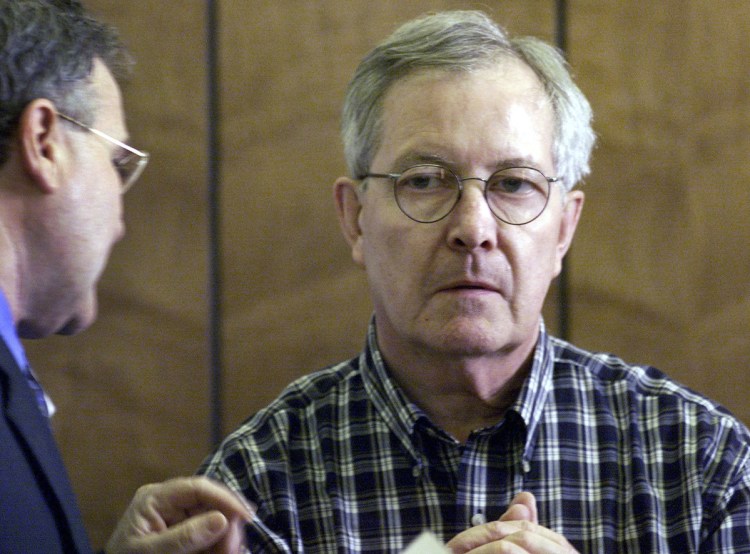  In this May 8, 2002, file photo, retired Catholic priest, the Rev. Ronald Paquin, right, talks with his Attorney, Kevin Reddington, left, during arraignment in District Court in Haverhill, Mass. Paquin was indicted Tuesday, Feb. 7, 2017, in Maine on 29 counts of sexual misconduct dating to the 1980s. Freed in 2015, Paquin was a central figure in the Boston archdiocese's sex abuse scandal. In 2002, he pleaded guilty to raping an altar boy. 