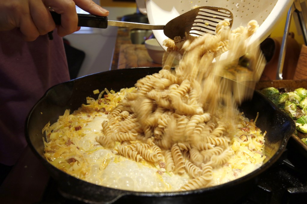 Pasta is added to the chorizo cream sauce.