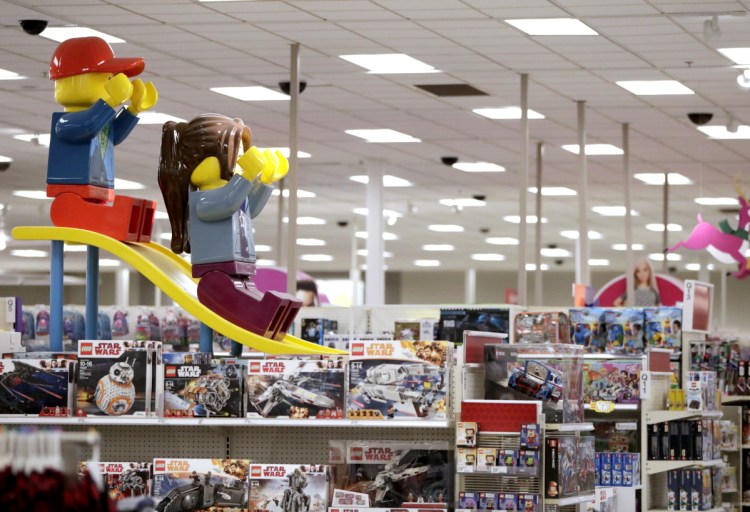 Two large Lego toys are displayed last week at a Target store in Bridgewater, N.J. Target's CEO estimates bankruptcies and closing have left $100 billion in market share up for grabs.