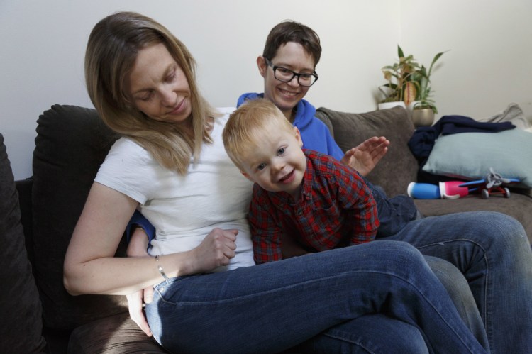 Anna Borman, left, and her partner, Sara Watson, play with their son, Eli, at home in Narragansett, R.I. Three years after the landmark U.S. Supreme Court case that gave same-sex couples the right to marry nationwide, a patchwork of outdated state laws governs who can be a legal parent.