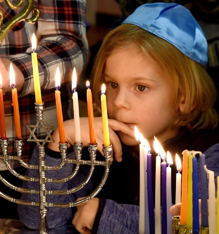 Candles on a Menorah lighted last Dec. 17 at Beth Israel Synagogue in Waterville represent hope emerging in darkness – a theme emphasized in filmmaker David Anton's 'Hanukkah: A Festival of deLights.'